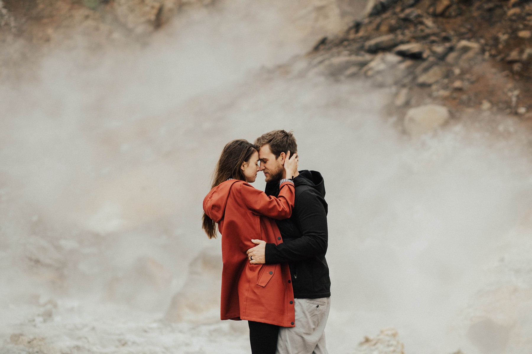couple posing for steamy photo with fog in background